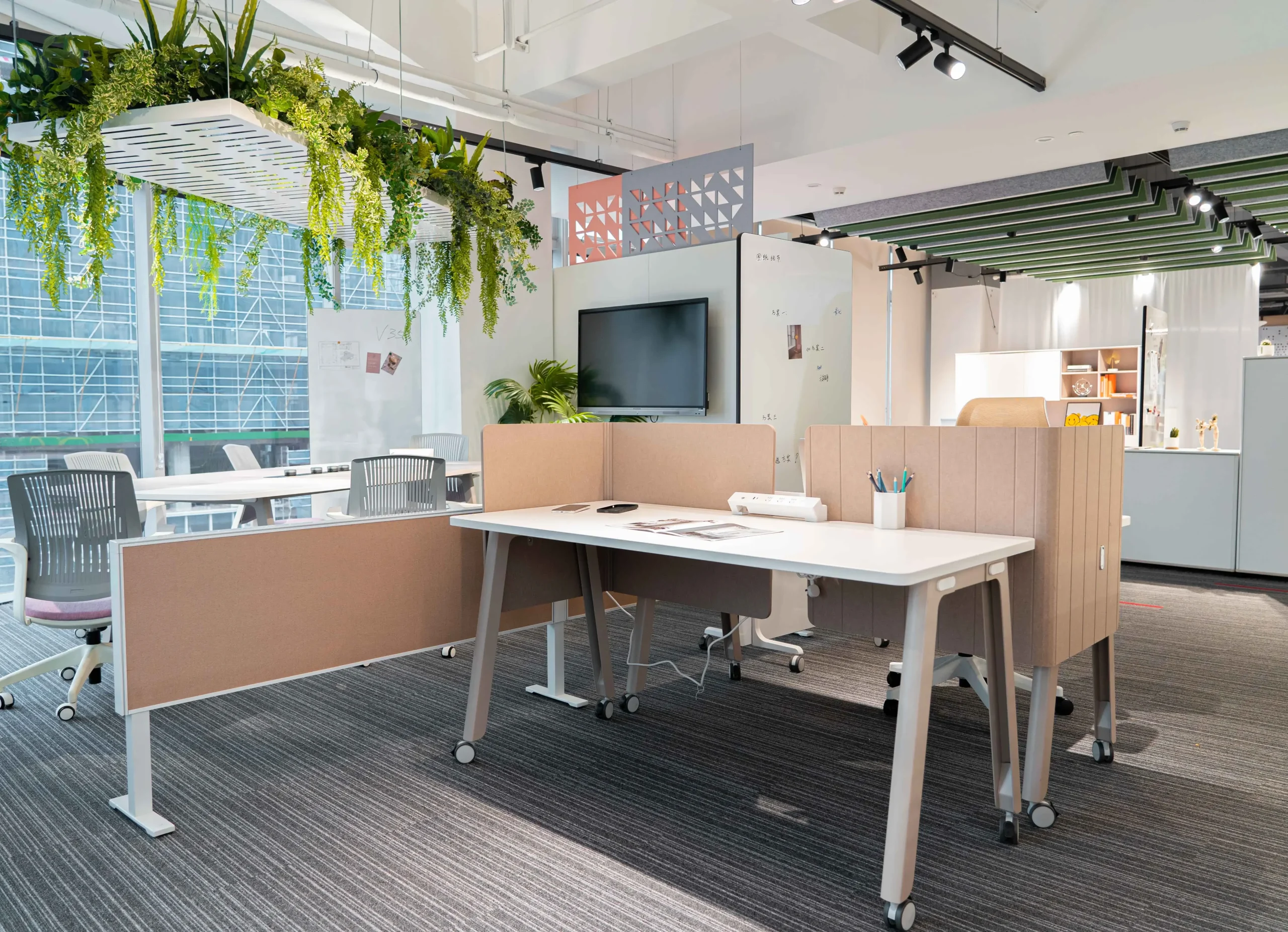 Modern office with desks chairs and hanging plants