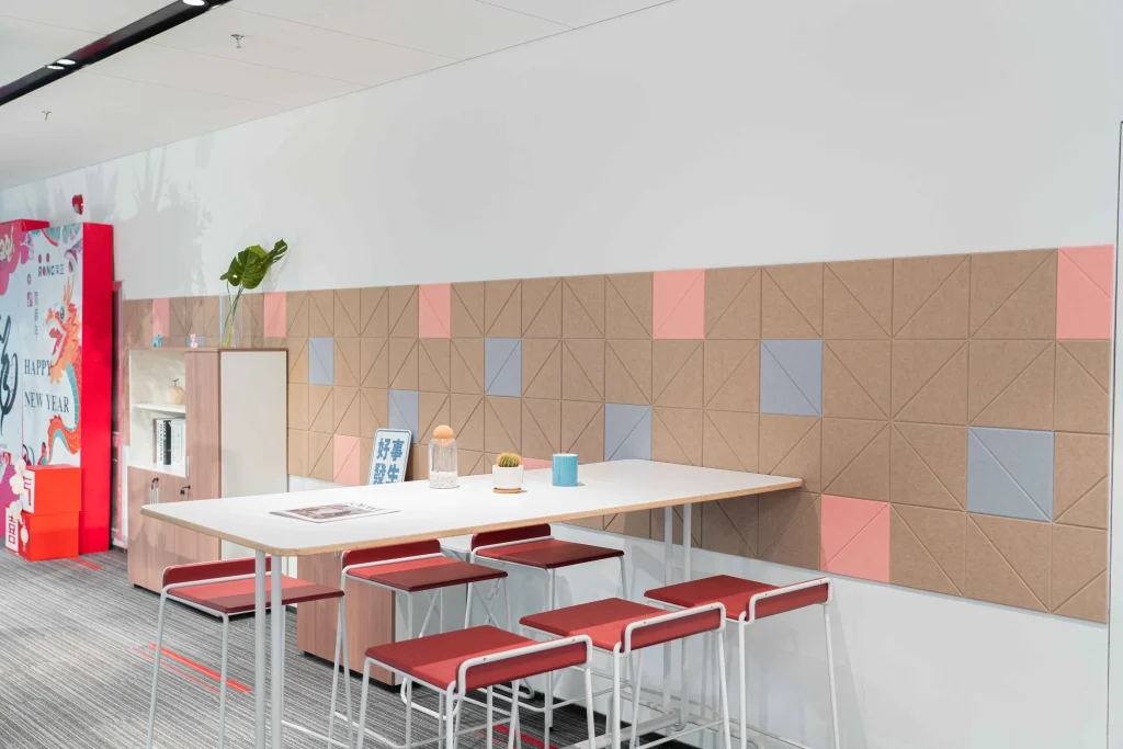 Lounge area with bar stools and geometric wall panels